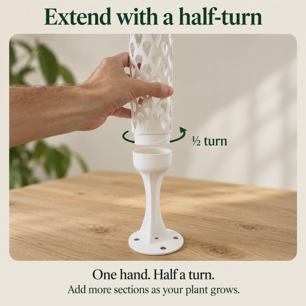 Close-up of one hand connecting a white teardrop-pattern moss pole extension to its anchored base. A half-turn arrow shows the quick threaded connection, which allows additional sections to be added as the climbing plant grows.
