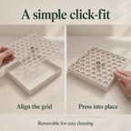 Two views demonstrate fitting the removable honeycomb grid into its shallow drip tray. On the left, a hand aligns the grid above the tray; on the right, a hand presses its edge into place. The grid can be removed for cleaning.
