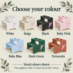 Seven open-front, open-back plant stands in White, Beige, Black, Baby Pink, Baby Blue, Dark Green and Terracotta. Each has two shelves with five circular pot openings and a pink side logo. Text notes that bundled pots are supplied in white.