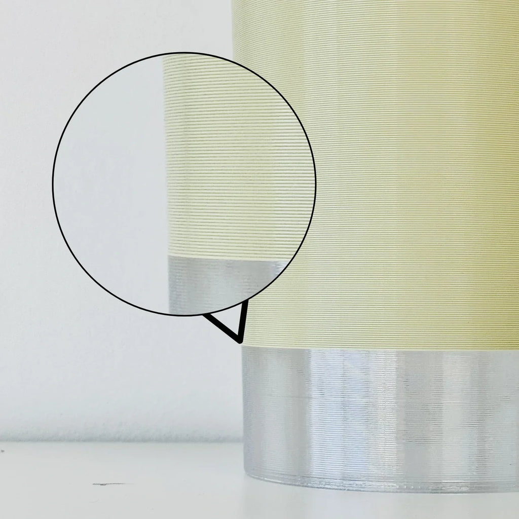 Close-up of cream and silver 3D printed plant pot texture, showing fine layer lines